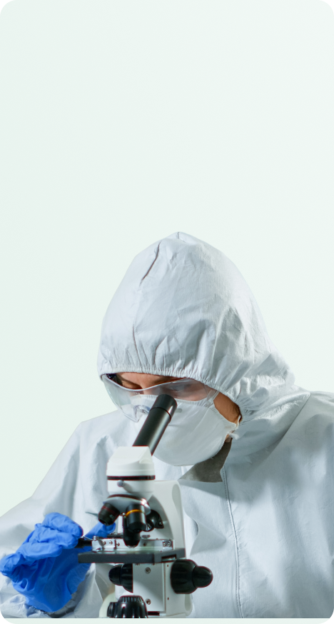 A lab scientist examining a sample under a microscope