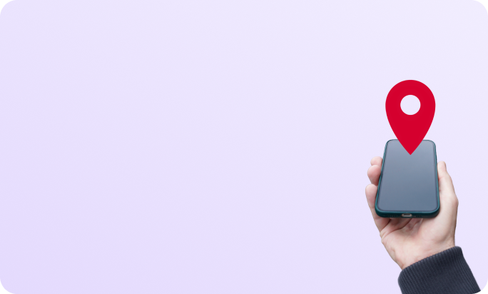 A hand holding a phone with a location pin